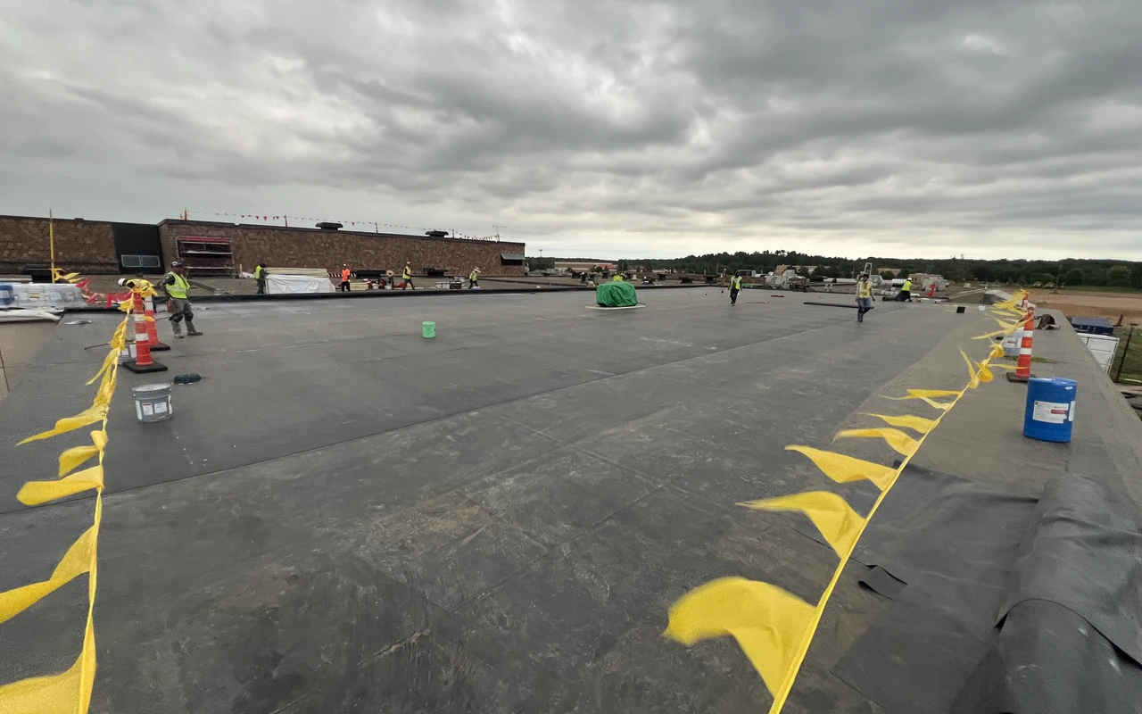 Storm damage roof replacement crew on commercial property in Twin Cities, MN by Altus Roofing